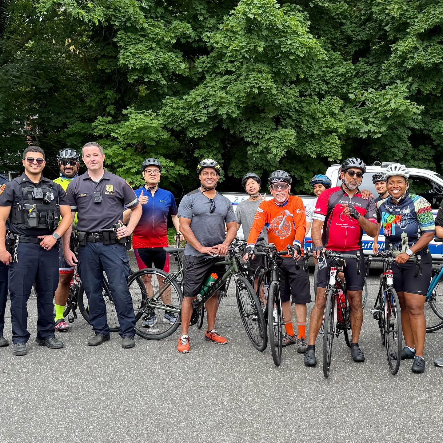 Team C4C riders with officers at the 5 Boro Bike Tour