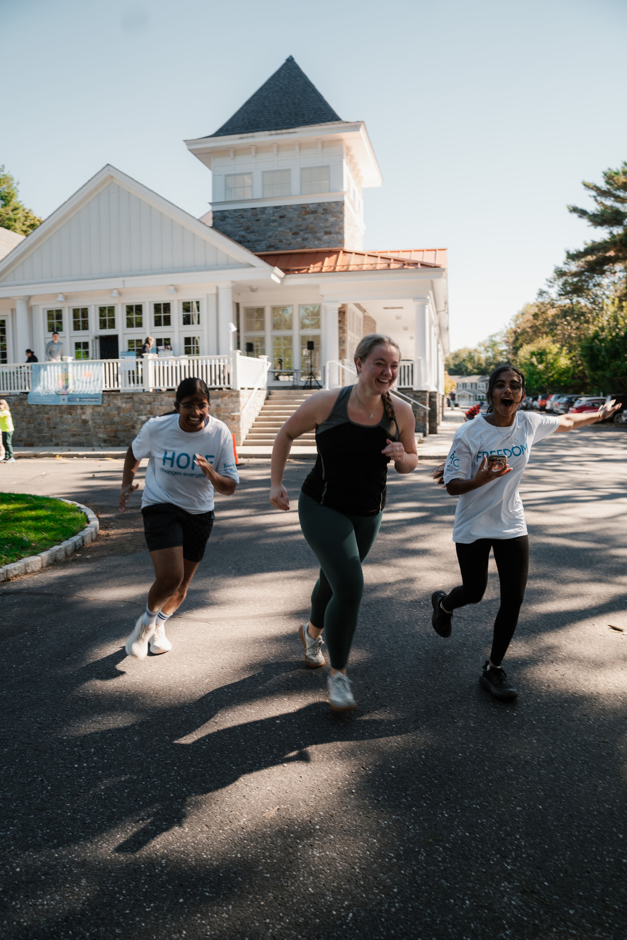 Runners in Hope and Freedom shirts racing toward the finish