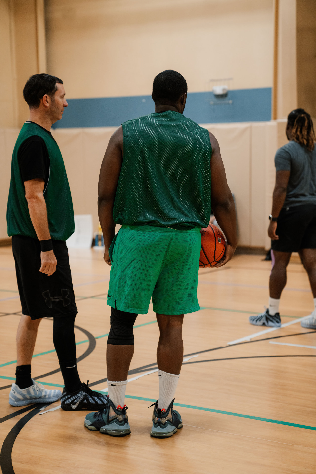 Basketball players talking on the court