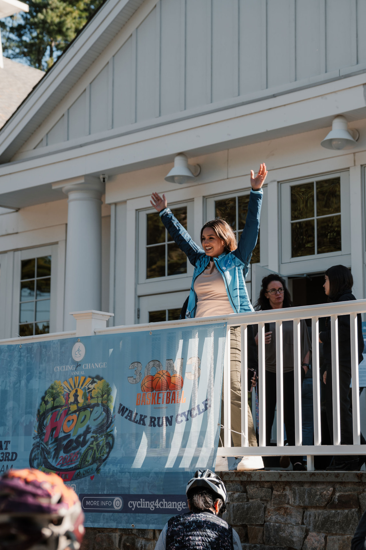 Host cheering from the balcony above the Hope Fest banner
