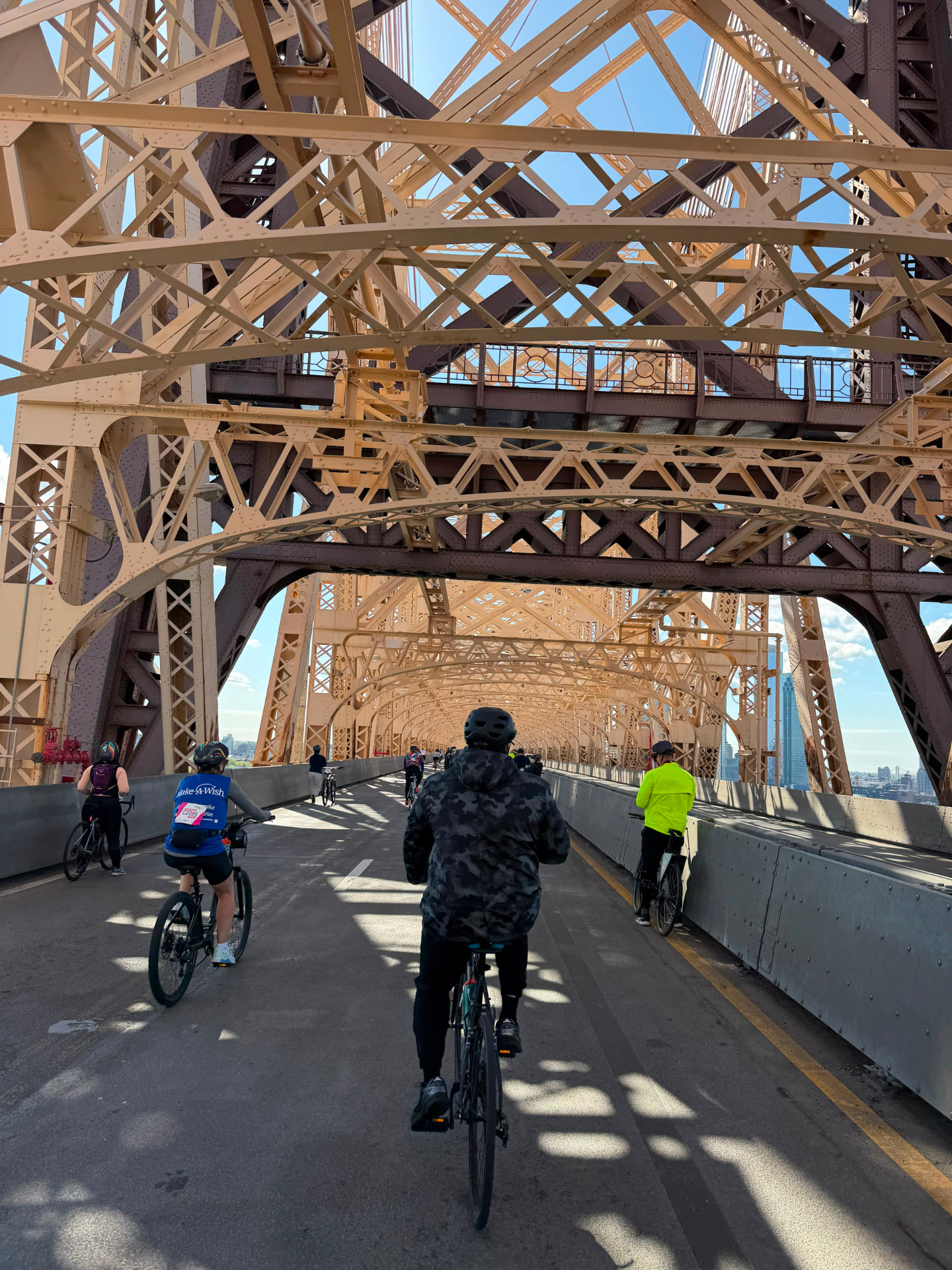 Cyclists crossing a New York City bridge on the tour route