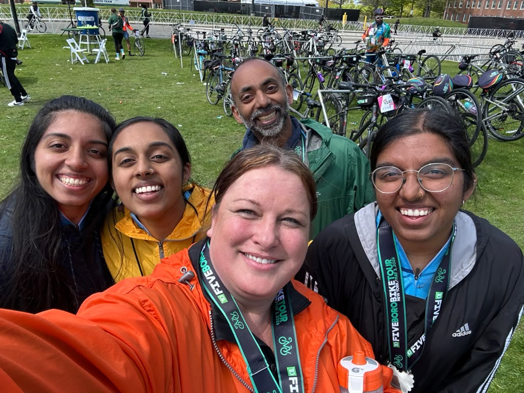 Team C4C riders taking a group selfie in the bike corral