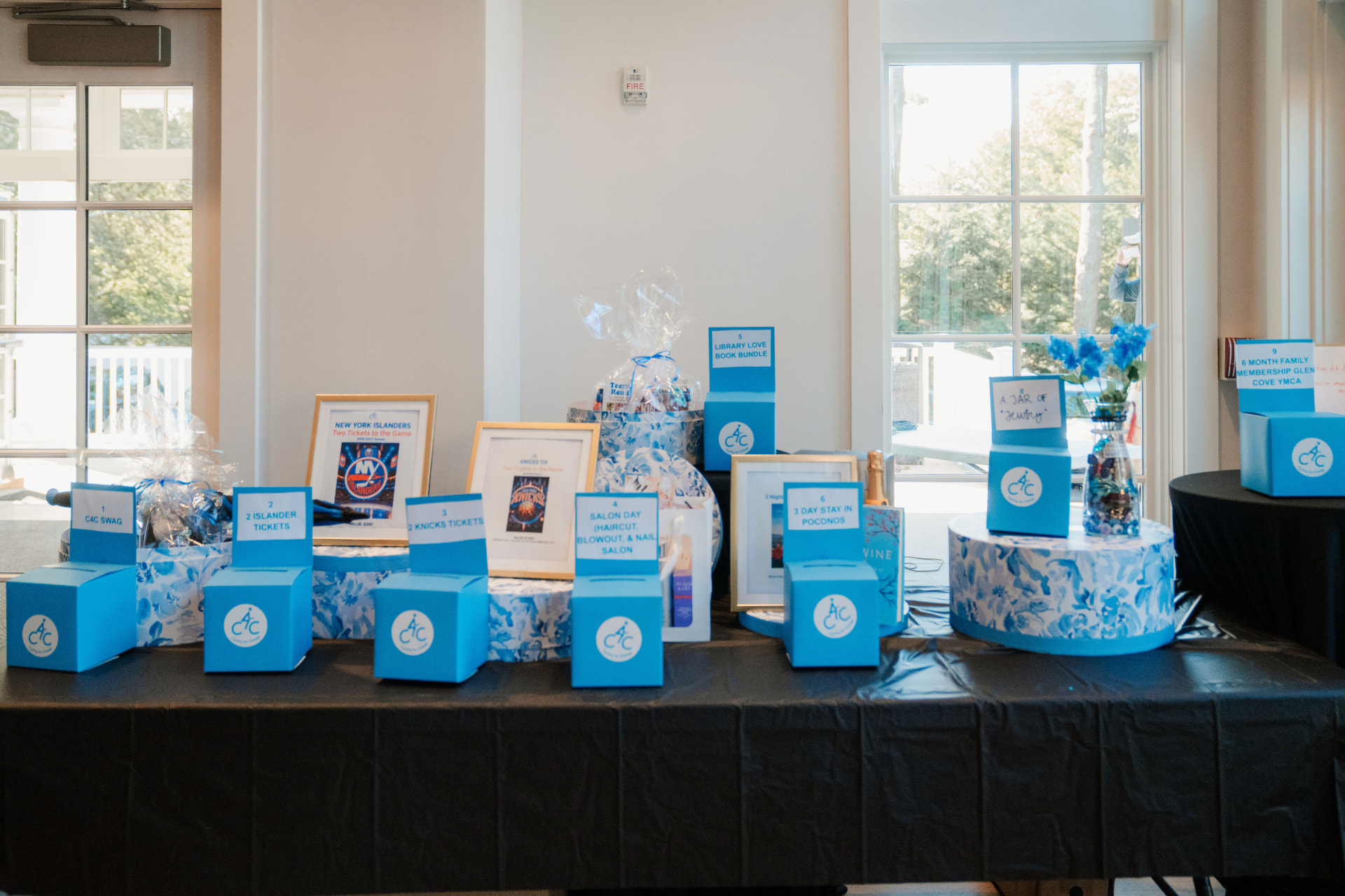 Raffle prizes and ticket boxes on a display table