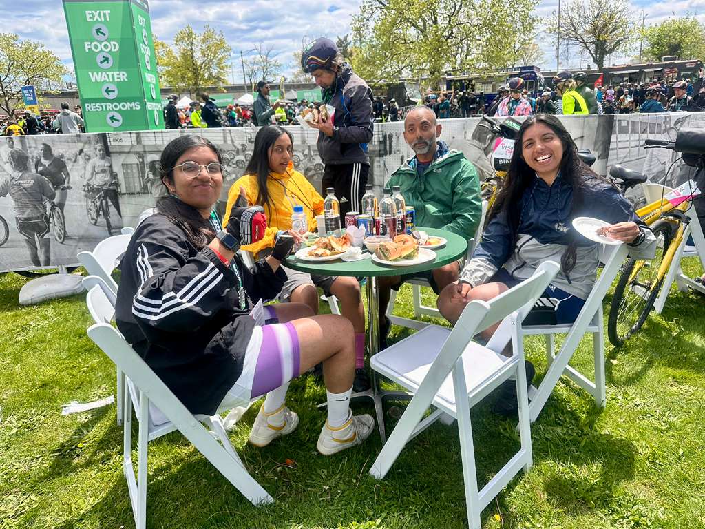 Team C4C riders sharing a meal at a tour rest stop
