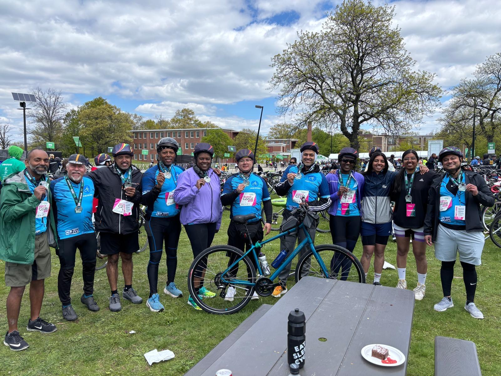 Team C4C riders holding up their finisher medals